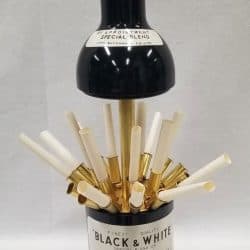 A bottle opened from the middle with cigarettes hiding inside