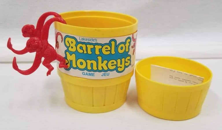Two red monkeys hanging out of a yellow barrel that holds all the money pieces.