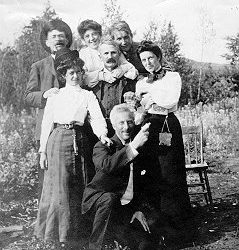 Black and white photo of 7 people posing for a photo