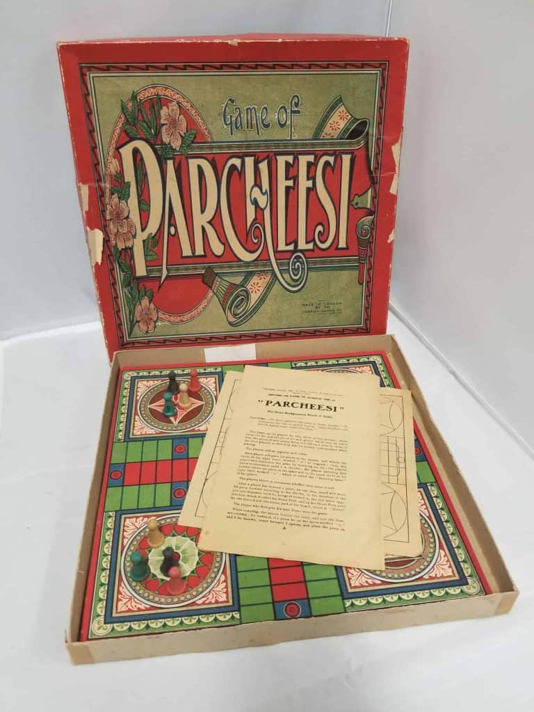 Board game Parcheesi with the instruction manual on top.