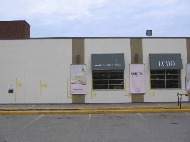 Marks along a wall showing where to stand outside the LCBO to keep people distanced