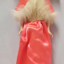 Barbie Doll with brown hair, wearing a coral dress with a fur-lined cape.