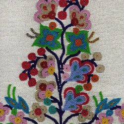 Seed beads in floral pattern on heavily beaded background. This is a detail of a much larger pouch. The bead pattern here is similar to Ojibway bandolier bags in the Museum’s collection. Ojibway manufacture, circa 1930