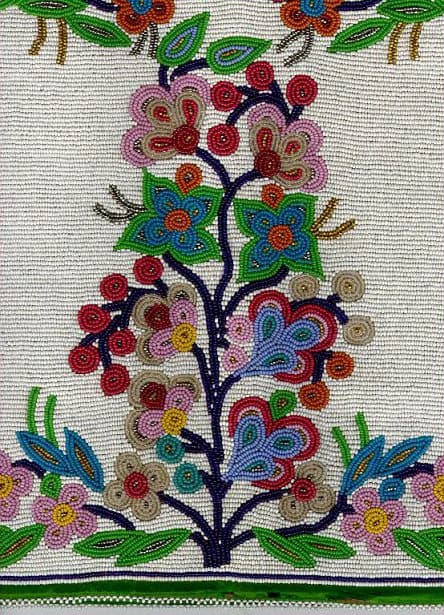 Seed beads in floral pattern on heavily beaded background. This is a detail of a much larger pouch. The bead pattern here is similar to Ojibway bandolier bags in the Museum’s collection. Ojibway manufacture, circa 1930