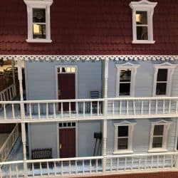 Two and a half story dollhouse with wrap around porches on both floors
