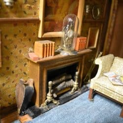 Fireplace with mantle and items across the mantle.