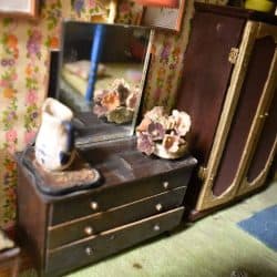 Dresser with a mirror and vases on top.