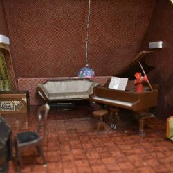 Music room with a piano and a couch.