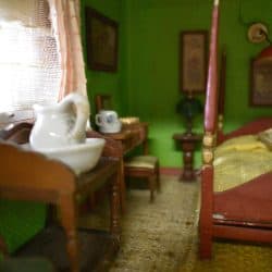 Window and table in a green bedroom.