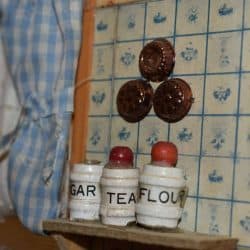 Canisters in the kitchen on a shelf.