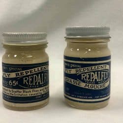 Two small jars labeled as fly repellent