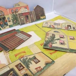 Paper doll house pieces that can form a village.