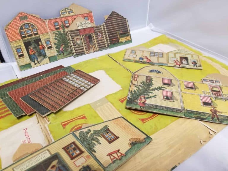 Paper doll house pieces that can form a village.