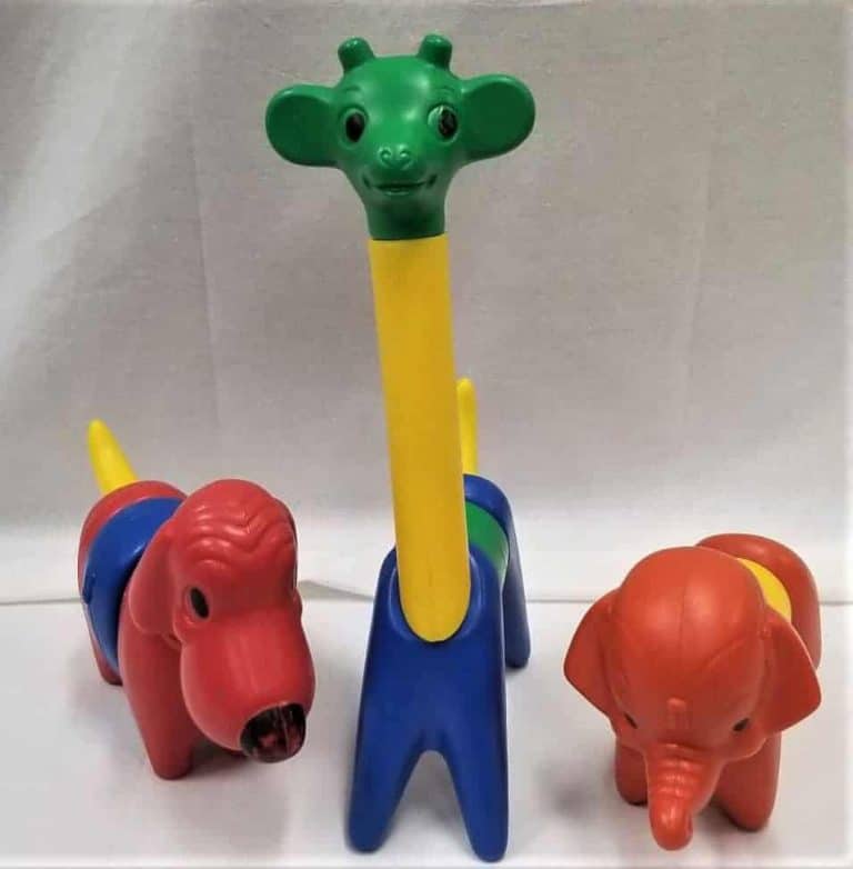 Plastic puzzle animals including a dog, giraffe, and elephant. The puzzle pieces are all different colours.