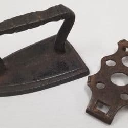 Toy metal iron and trivet circa 1895.