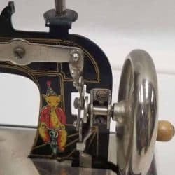 Antique Toy Sewing Machine - Closeup of the hand wheel.