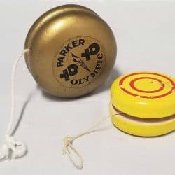 Two yo-yos, one gold, one yellow with red circles on it